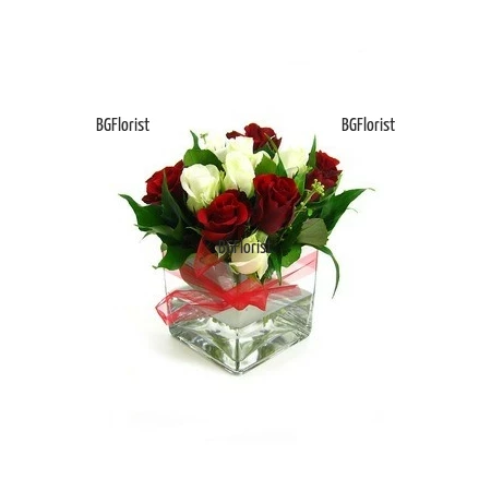 Send an arrangement of roses in glass container by Internet order.